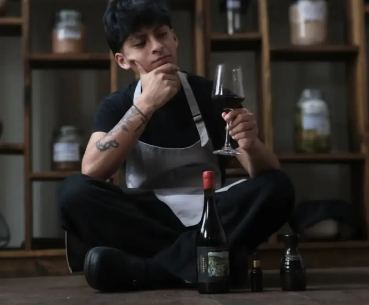 Integrante del equipo de Nativa con una copa de vino tinto